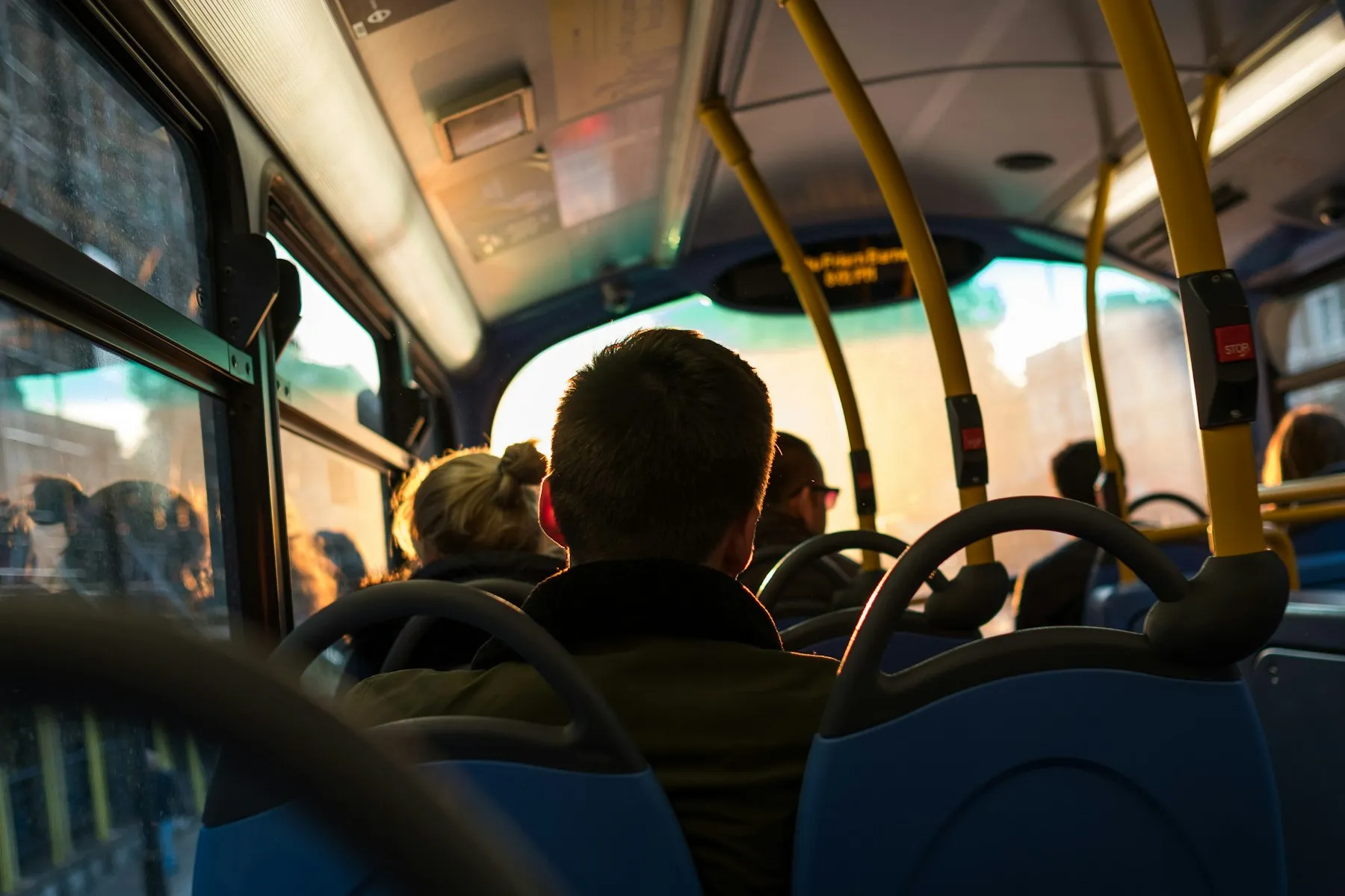 A passenger seated inside a public bus