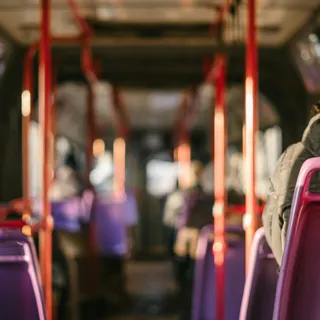 A person standing inside a public transit vehicle
